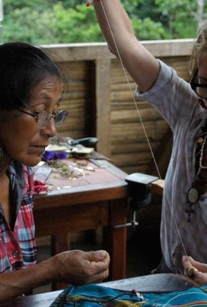 Julie Wolfe working with a local artist