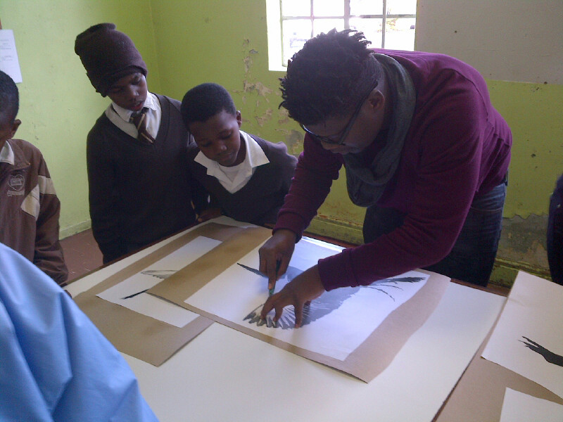 Students line up to help cut stencils for the art project - Pretoria
