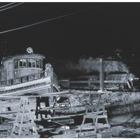 O Winston Link, Colonna Shipyards, Train in Background, Norfolk, Virginia, Gelatin silver photograph, 26 3/8 x 22 5/8 in.  (67.0 x 57.5 cm) framed, Courtesy of Norfolk Southern Corporation, Norfolk, Virginia