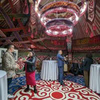 At a reception at the residence of U.S. Ambassador David Rosenblum in Astana, American artist Ángel Rafael Vázquez-Concepción talks with assembled guests including Kazakh artist and activist Karipbek Kuyukov.